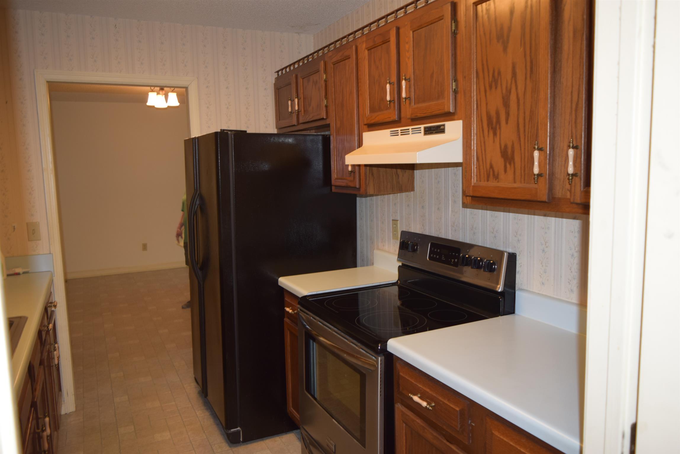121 Asbury Road Manchester, TN 37355 - Photo 4 of 13 a kitchen with a refrigerator and a stove