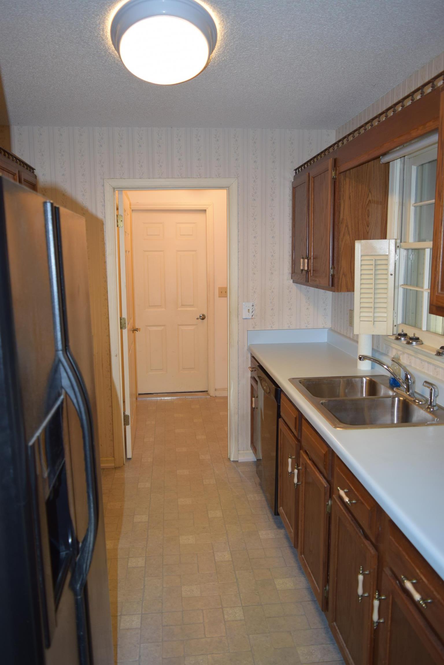 121 Asbury Road Manchester, TN 37355 - Photo 5 of 13 a kitchen with stainless steel appliances granite countertop a sink stove and refrigerator