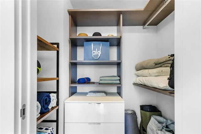 a room with a bed and a book shelf