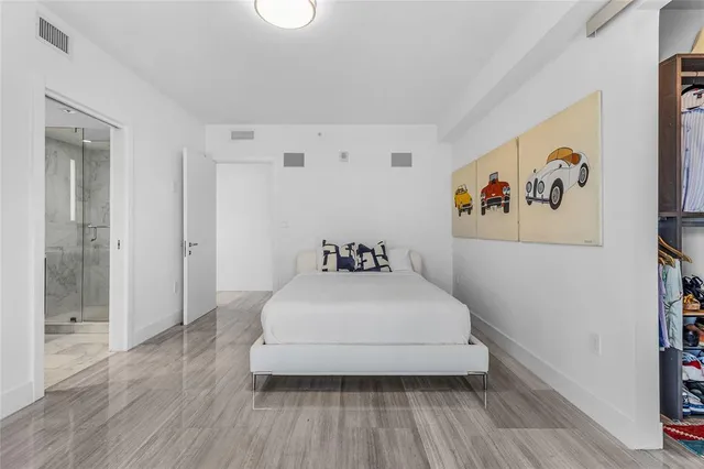 a bedroom with a bed and a large window