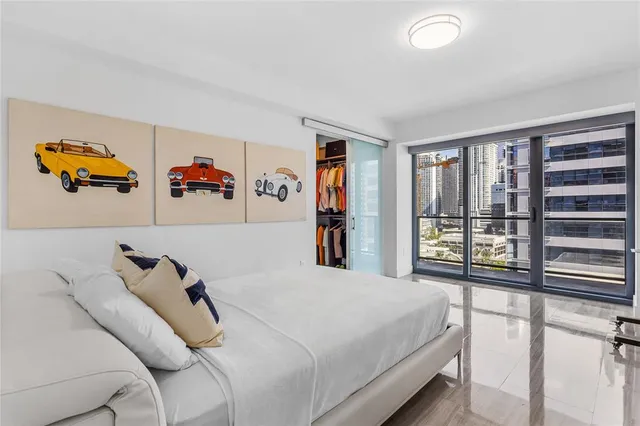 a bathroom with a double vanity sink toilet and two mirror