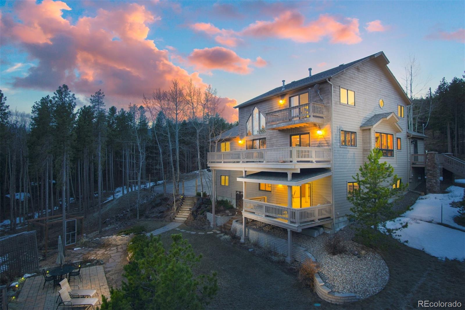 a view of a chairs and table in backyard