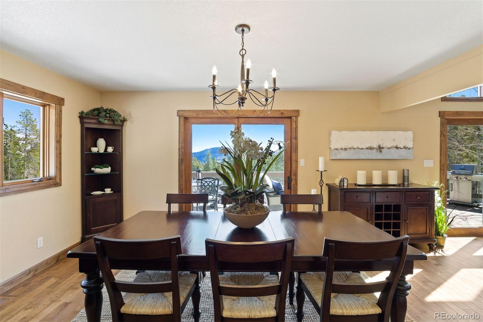 8331 South Warhawk Road Conifer, CO 80433 - Photo 12 of 40 a view of a dining room with furniture window and wooden floor