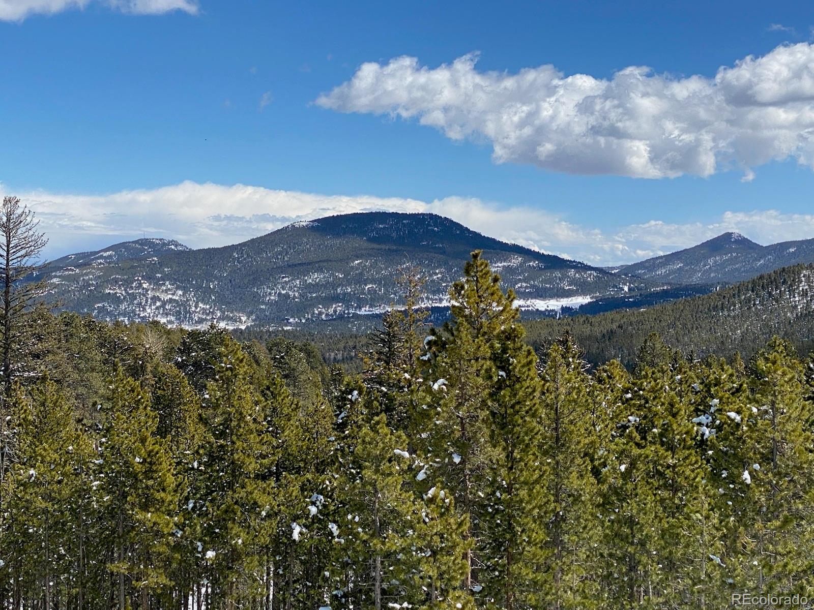 8331 South Warhawk Road Conifer, CO 80433 - Photo 14 of 40 a view of a house with a mountain in the background