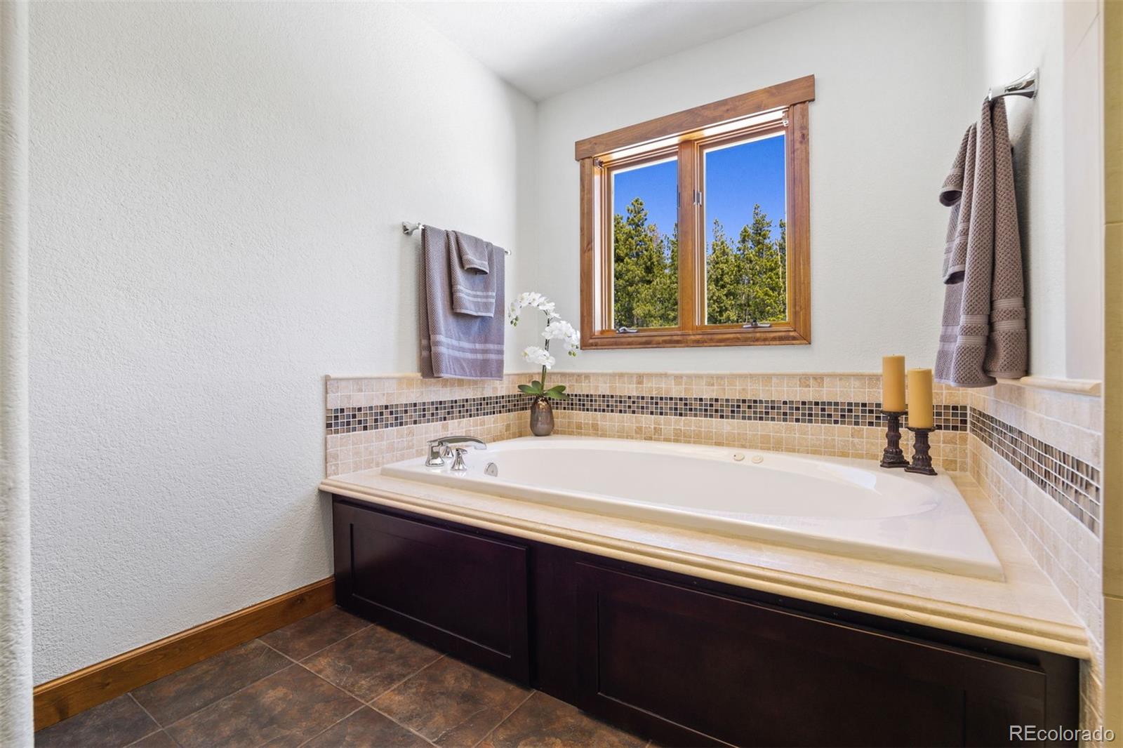 8331 South Warhawk Road Conifer, CO 80433 - Photo 20 of 40 a bathroom with a bathtub and a sink