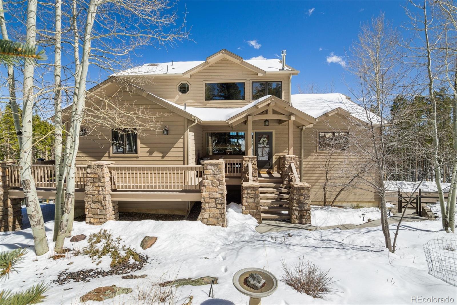8331 South Warhawk Road Conifer, CO 80433 - Photo 2 of 40 a front view of a house with a yard
