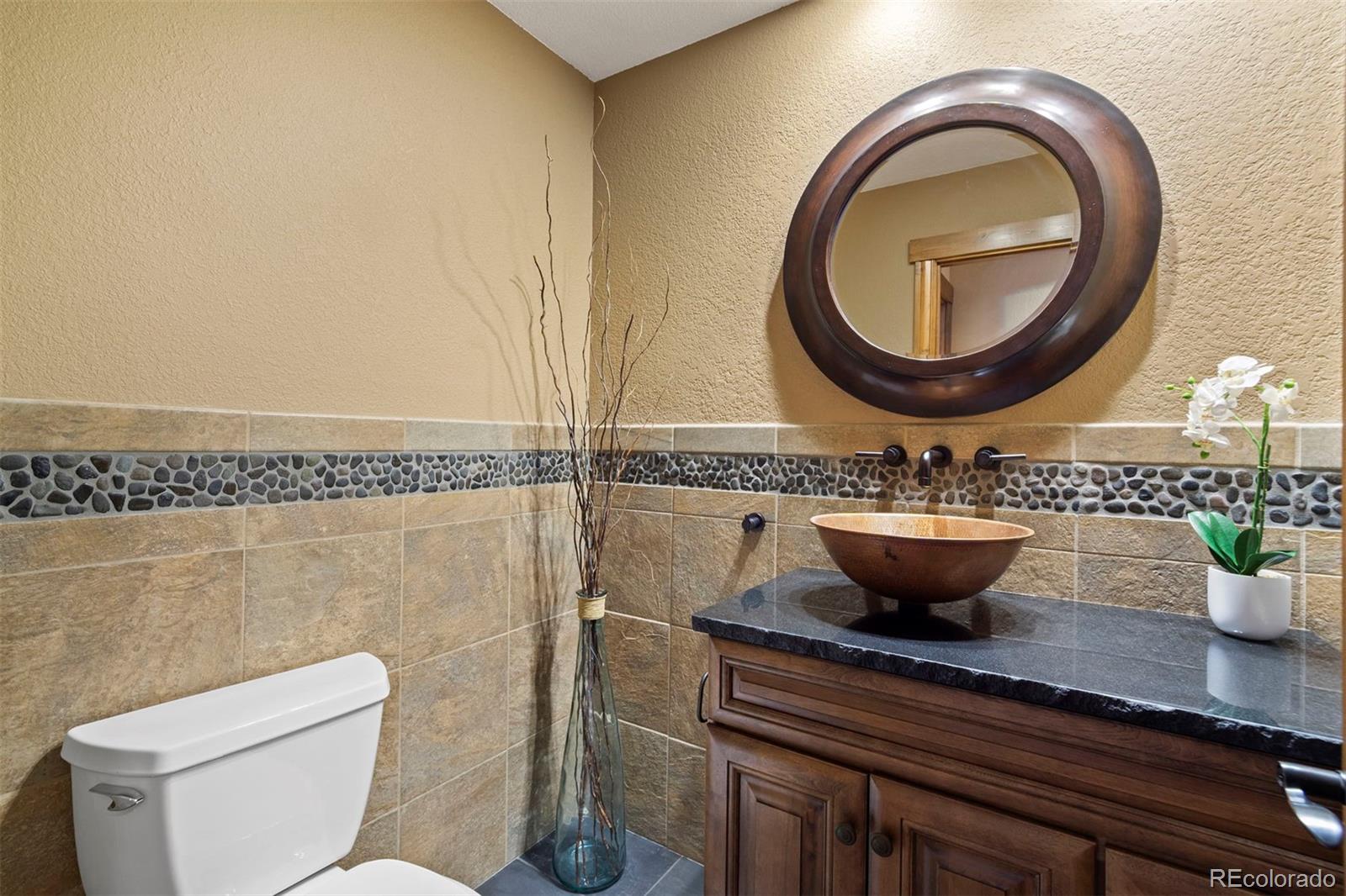 8331 South Warhawk Road Conifer, CO 80433 - Photo 26 of 40 a view of a bathroom with a potted plant and a sink