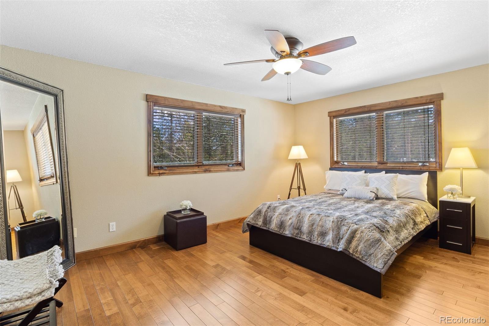 8331 South Warhawk Road Conifer, CO 80433 - Photo 27 of 40 a bedroom with a bed and a chandelier