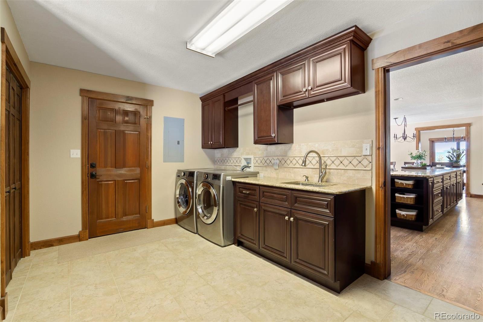 8331 South Warhawk Road Conifer, CO 80433 - Photo 29 of 40 a kitchen with stainless steel appliances granite countertop a refrigerator and cabinets