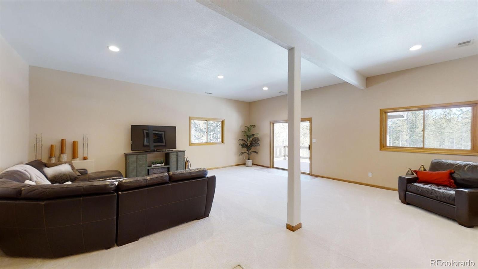 8331 South Warhawk Road Conifer, CO 80433 - Photo 30 of 40 a living room with furniture and a flat screen tv