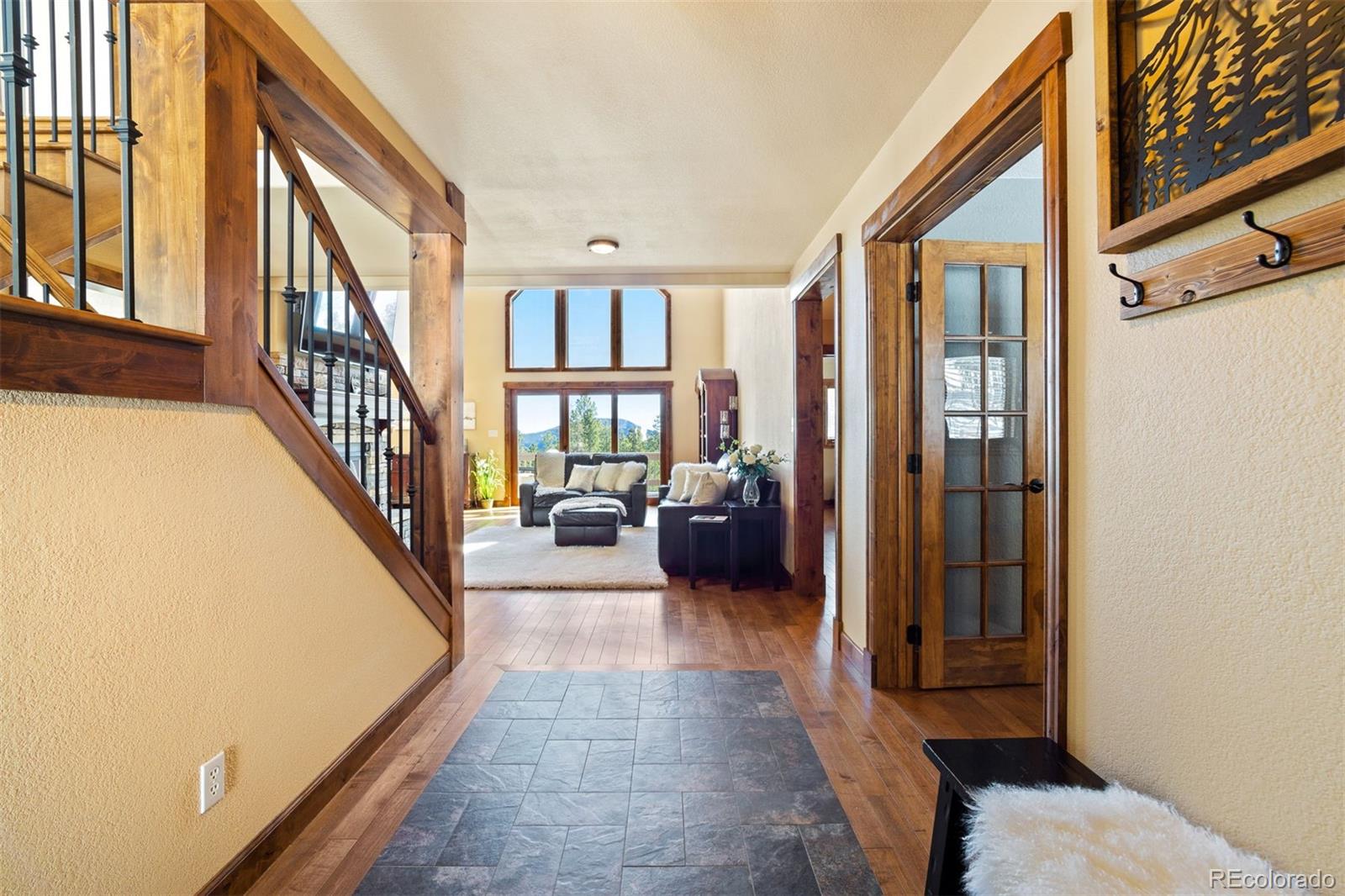 8331 South Warhawk Road Conifer, CO 80433 - Photo 4 of 40 a view of a livingroom with furniture and stairs