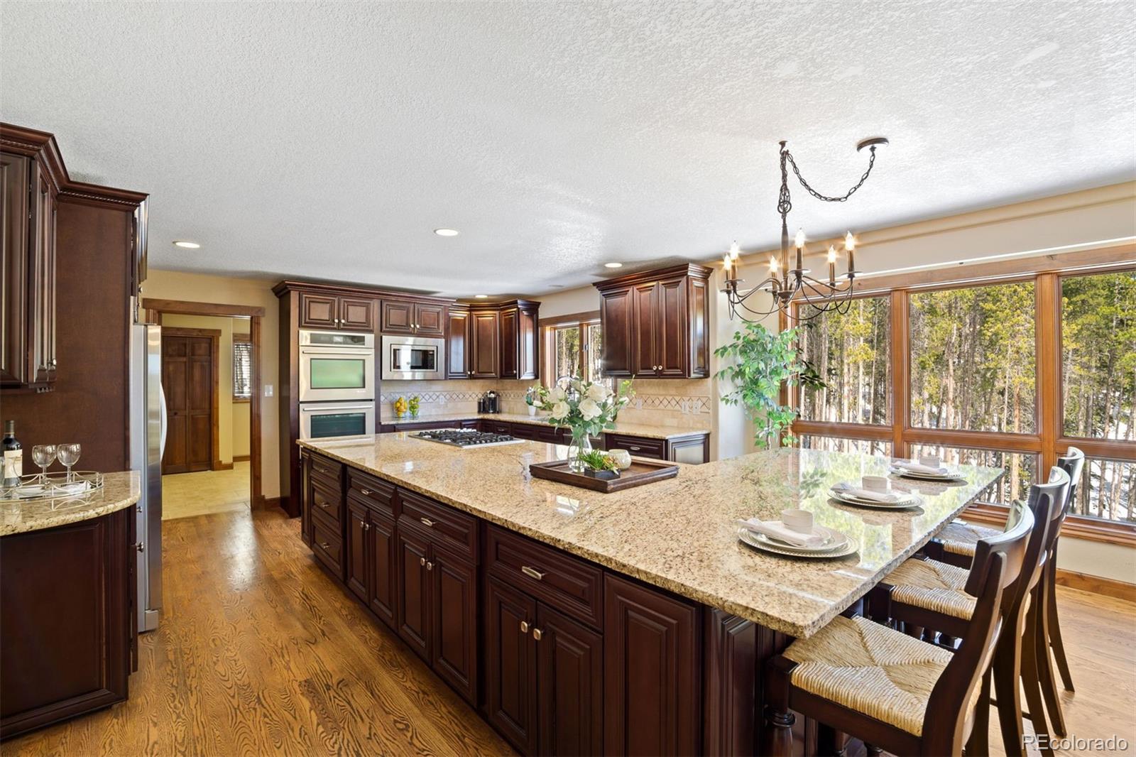 8331 South Warhawk Road Conifer, CO 80433 - Photo 7 of 40 a large kitchen with kitchen island a large island in it