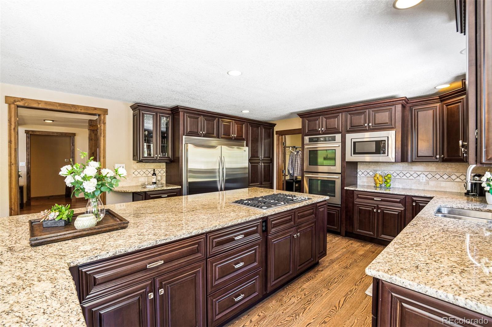 8331 South Warhawk Road Conifer, CO 80433 - Photo 8 of 40 a kitchen with stainless steel appliances granite countertop sink stove and refrigerator