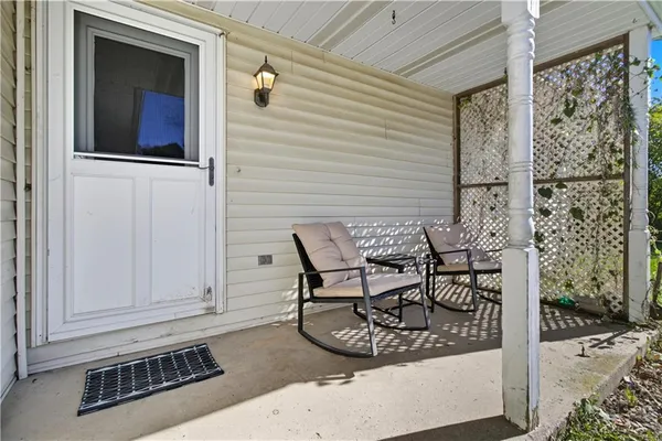 a view of a chairs and table in the back yard of the house
