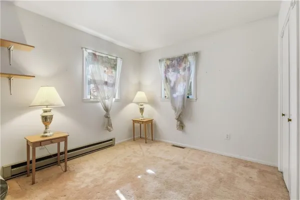 a view of a livingroom with furniture and a window
