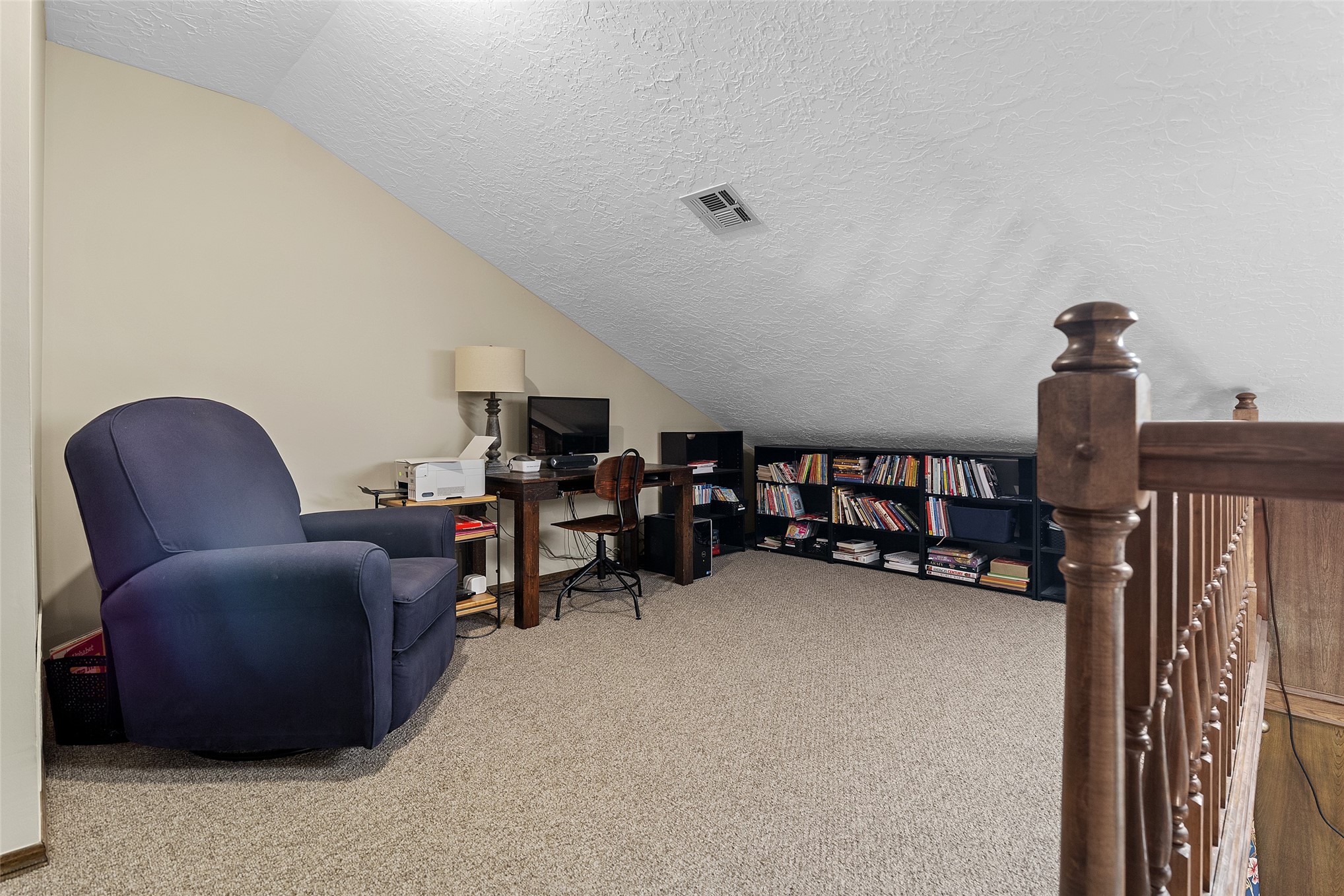 9644 19th Road Nowata, OK 74048 - Photo 25 of 36 Carpeted loft area with sloped ceilings and light beige walls