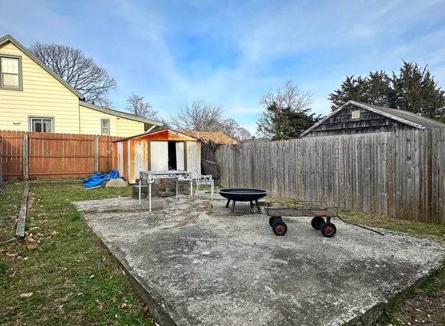 a view of backyard with a table and chairs