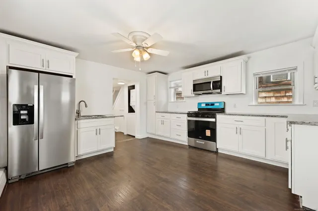 a kitchen with stainless steel appliances a refrigerator sink and microwave