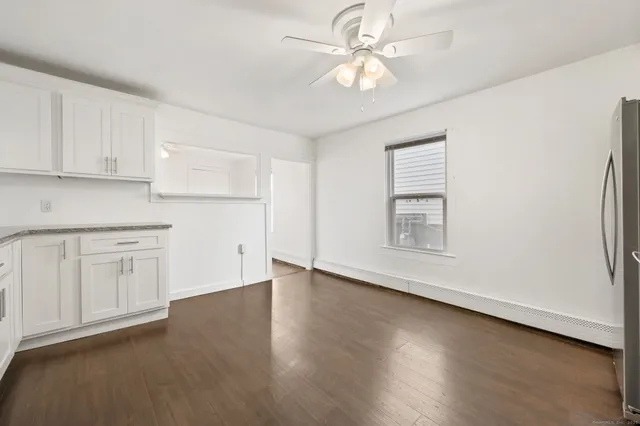 a view of an empty room with a kitchen