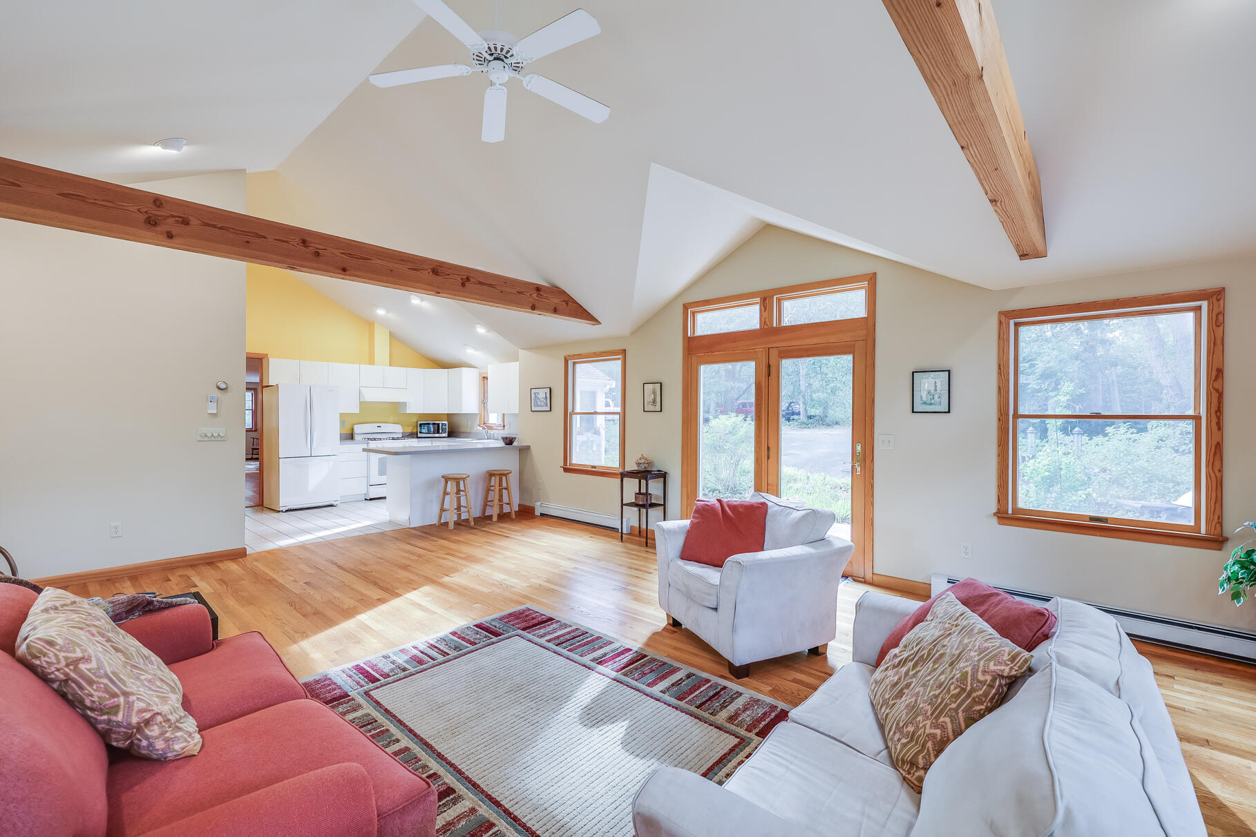 a living room with furniture and large windows