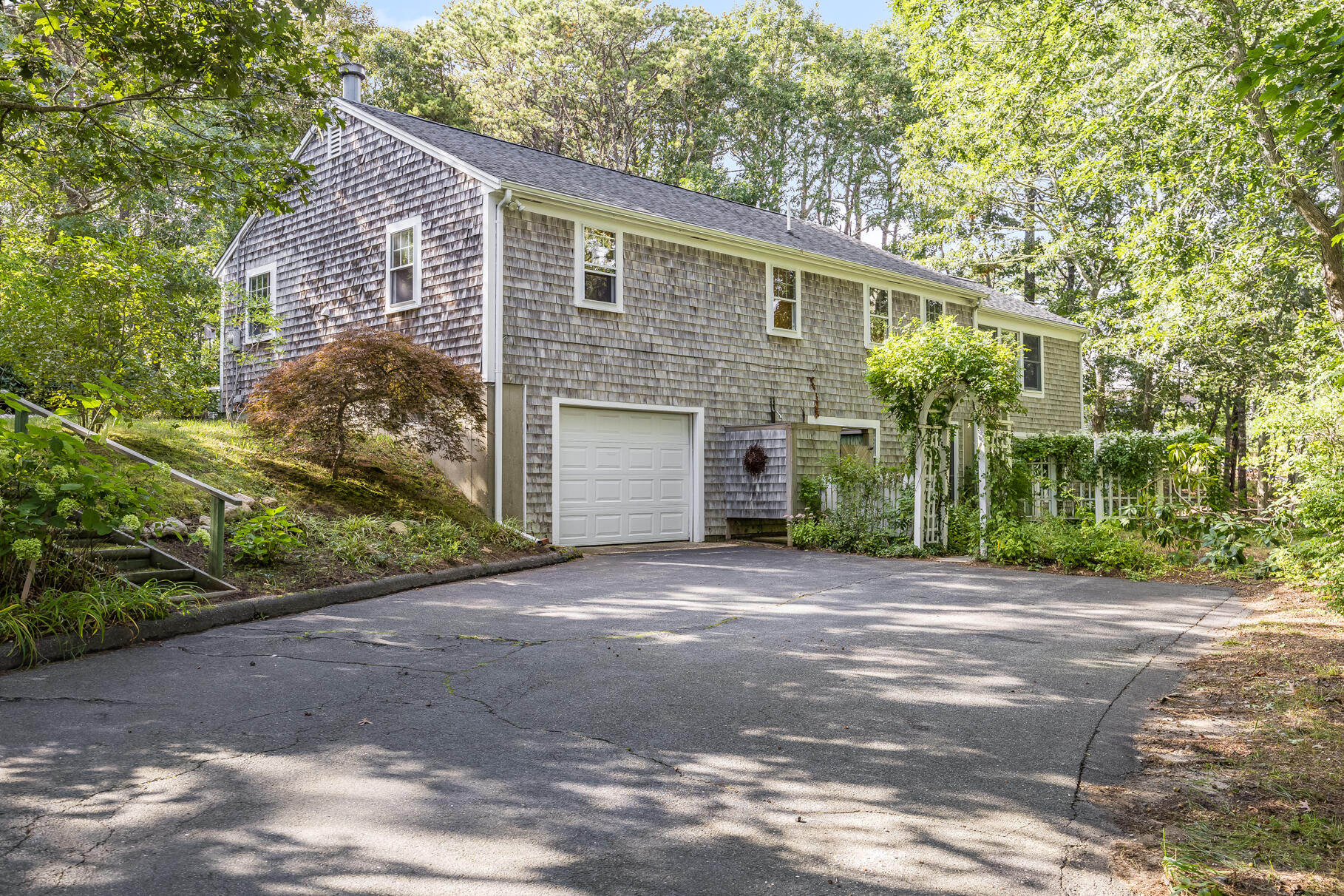 50 Slow Turtle Way Wellfleet, MA 02667 - Photo 24 of 37 a front view of a house with a yard and a garage