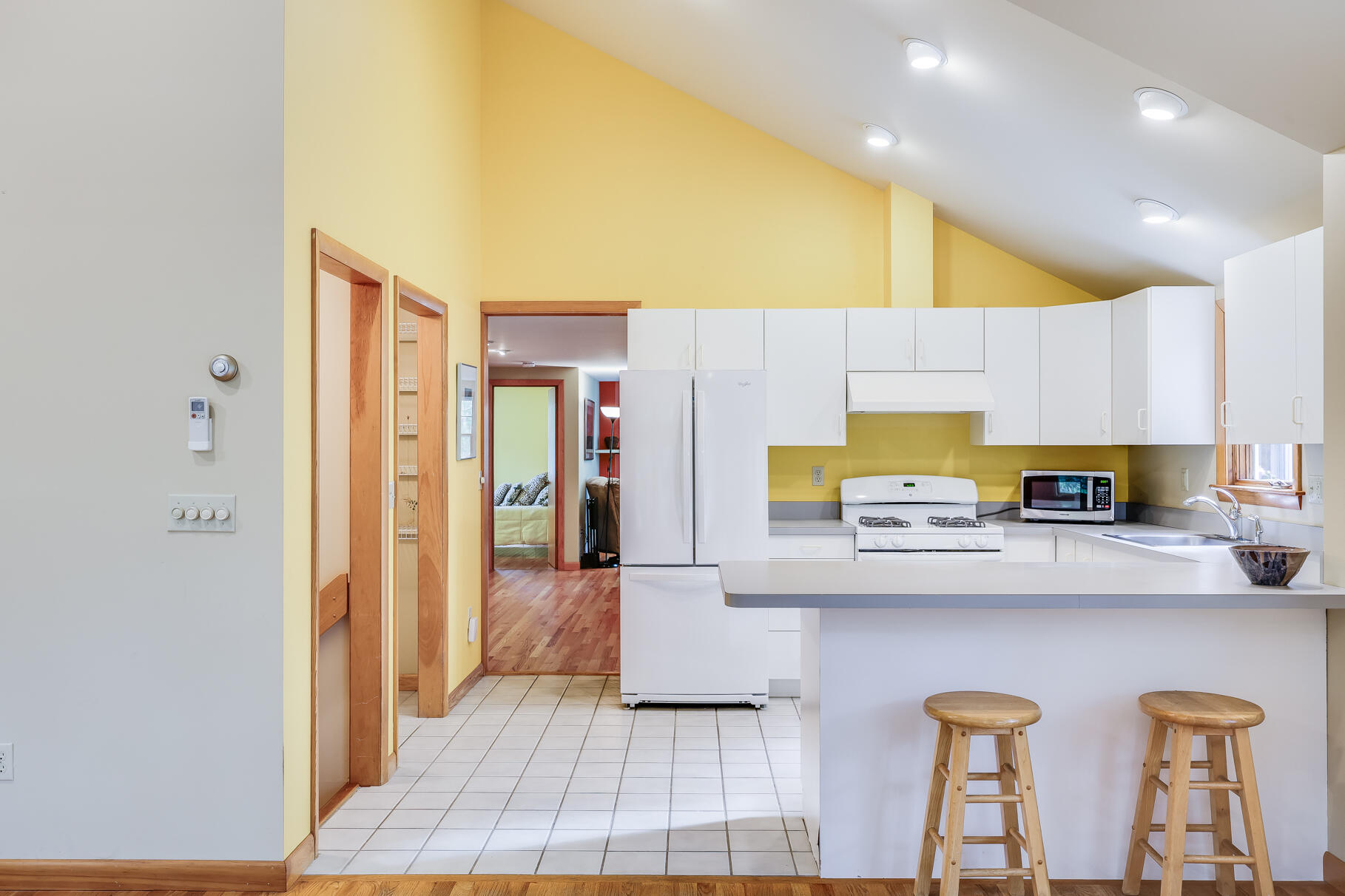 50 Slow Turtle Way Wellfleet, MA 02667 - Photo 5 of 37 a kitchen with stainless steel appliances a sink a stove a refrigerator cabinets and a dining table