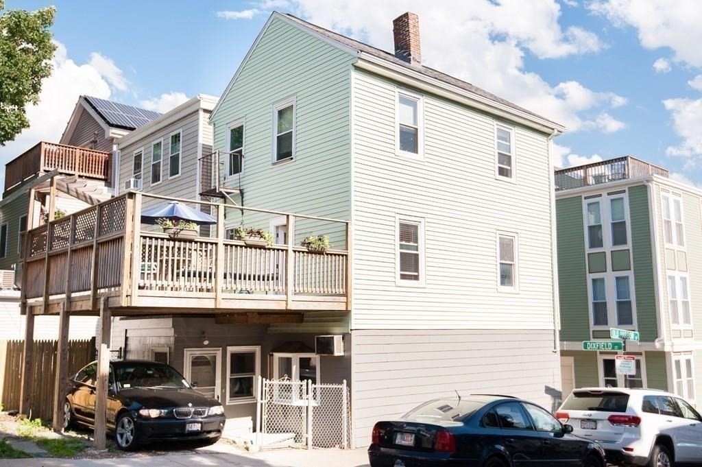a car parked in front of a white building