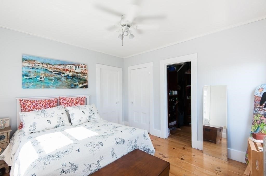 2 Dixfield Street, Unit SF Boston, MA 02127 - Photo 7 of 8 a bedroom with a large bed and a chandelier