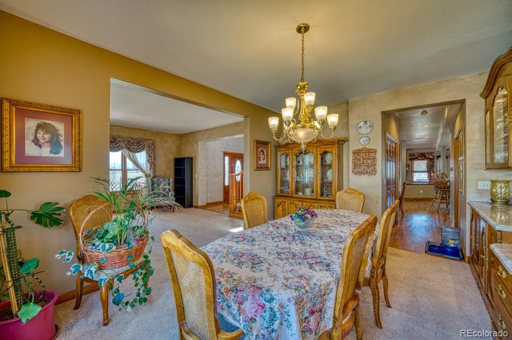 8283 Hygiene Road Longmont, CO 80503 - Photo 13 of 27 a dining room with furniture and chandelier
