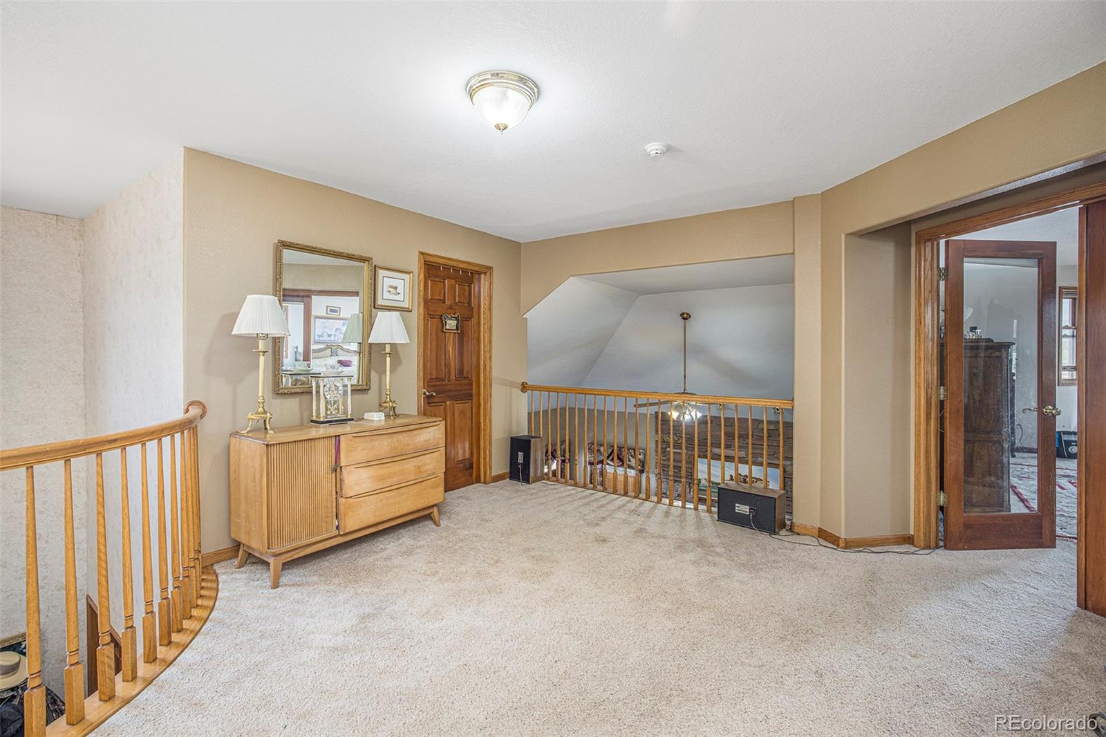 8283 Hygiene Road Longmont, CO 80503 - Photo 19 of 27 a large room with a baby crib and a dresser