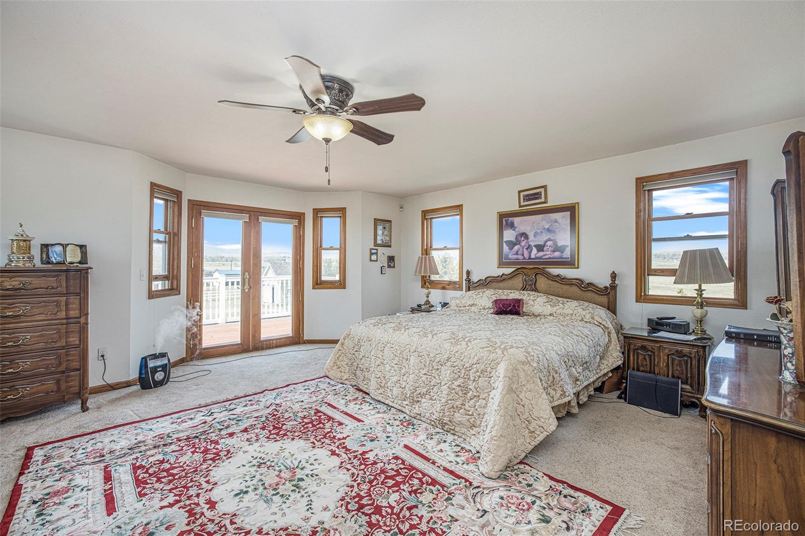 8283 Hygiene Road Longmont, CO 80503 - Photo 20 of 27 a spacious bedroom with a large bed and a window