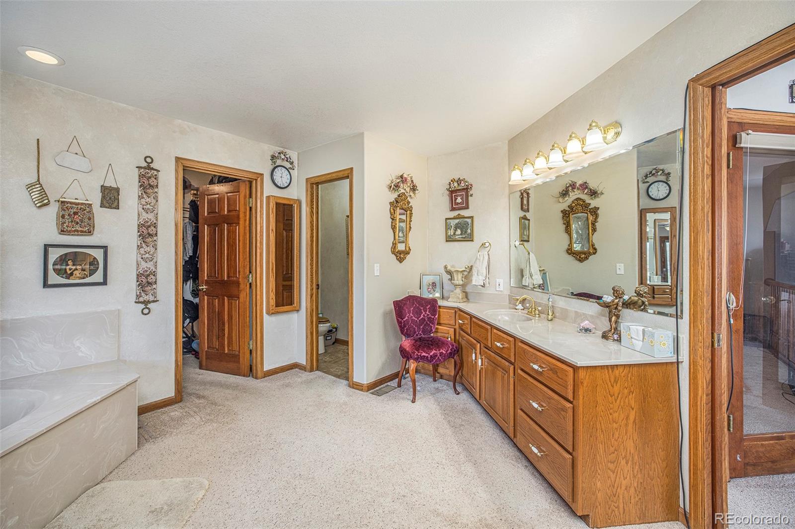 8283 Hygiene Road Longmont, CO 80503 - Photo 21 of 27 a spacious bathroom with a double vanity sink mirror and double