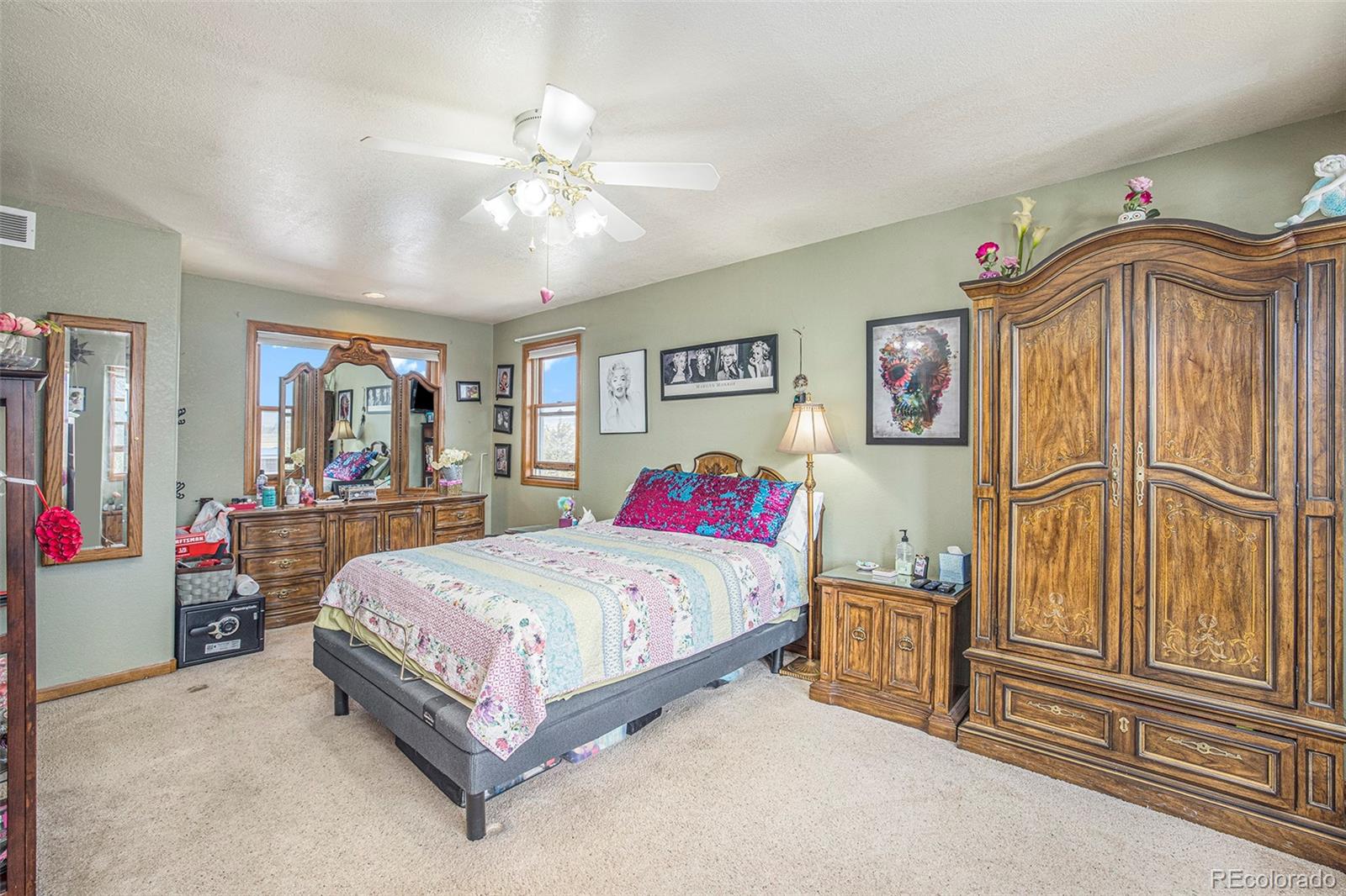 8283 Hygiene Road Longmont, CO 80503 - Photo 24 of 27 a bedroom with a bed painting on wall and a window