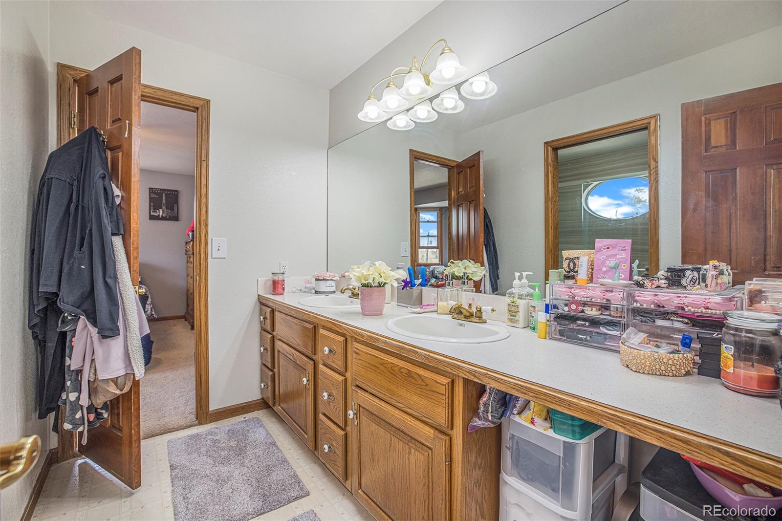 8283 Hygiene Road Longmont, CO 80503 - Photo 26 of 27 a spacious bathroom with a sink double vanity granite and a mirror