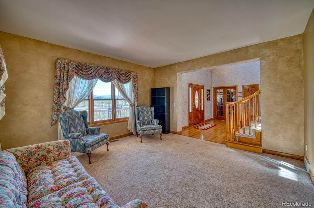 8283 Hygiene Road Longmont, CO 80503 - Photo 6 of 27 a living room with furniture and a flat screen tv