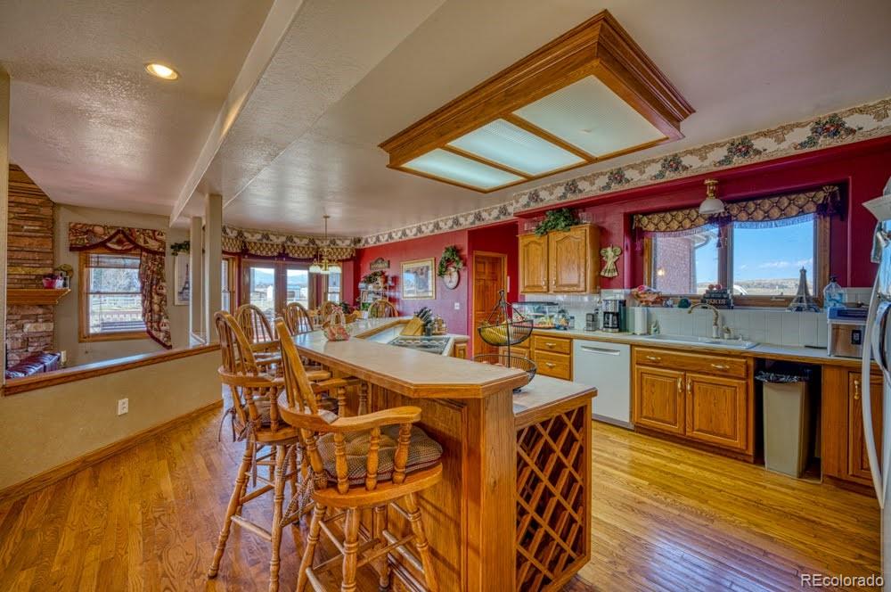 8283 Hygiene Road Longmont, CO 80503 - Photo 10 of 27 a view of a dining area with furniture and wooden floor