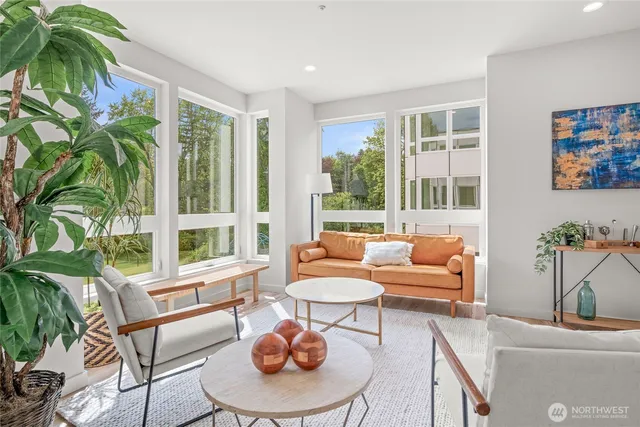 a living room with patio furniture and a potted plant