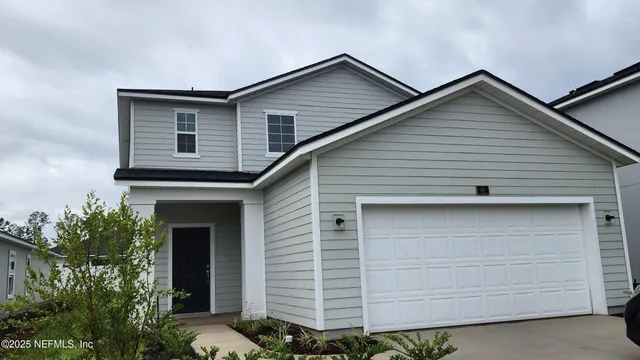 a front view of a house with garage