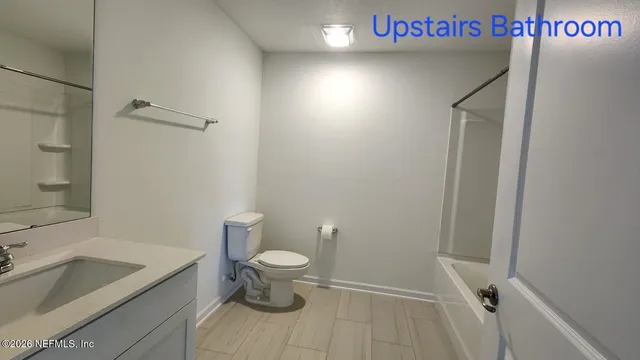 a view of a room with a ceiling fan and window