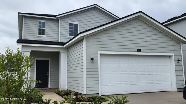 a front view of a house with garage