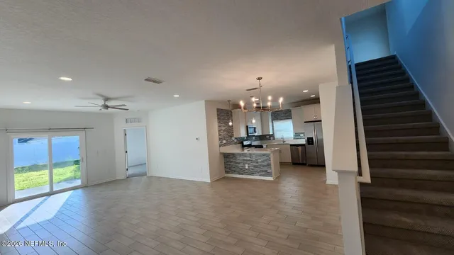 a view of a living room kitchen and a wooden floor