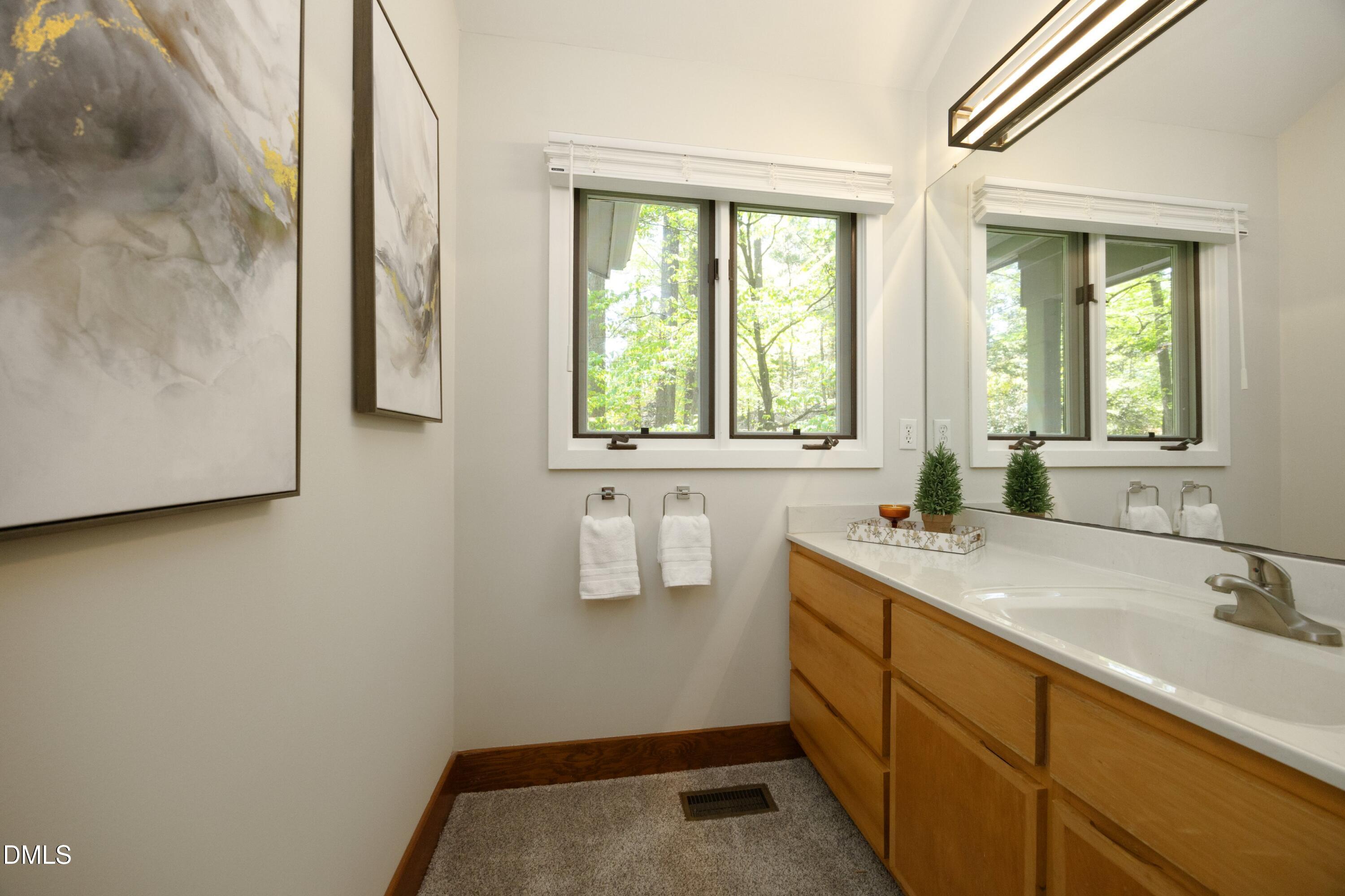 5321 Taproot Lane Durham, NC 27705 - Photo 15 of 27 a bathroom with a granite countertop sink and a window