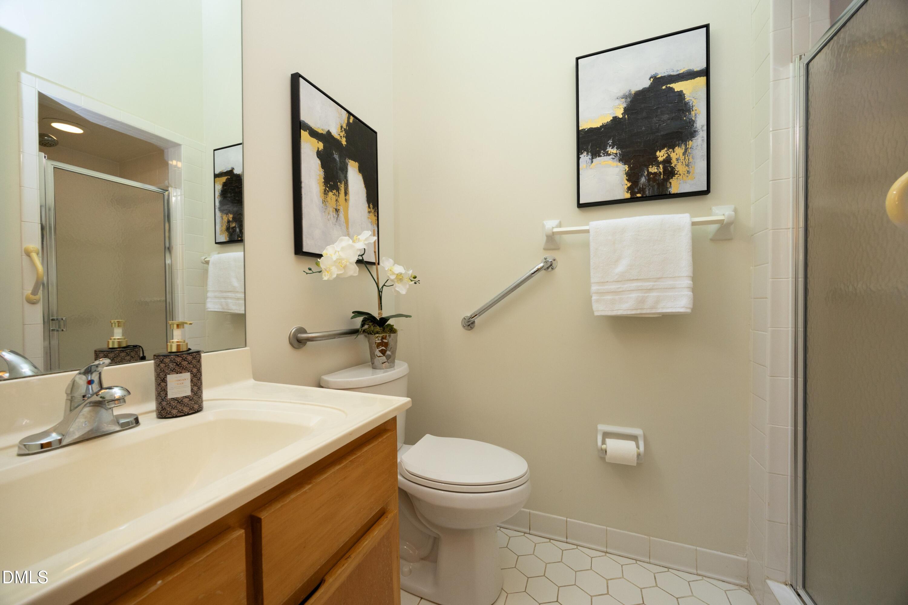 5321 Taproot Lane Durham, NC 27705 - Photo 18 of 27 a bathroom with a toilet sink and mirror