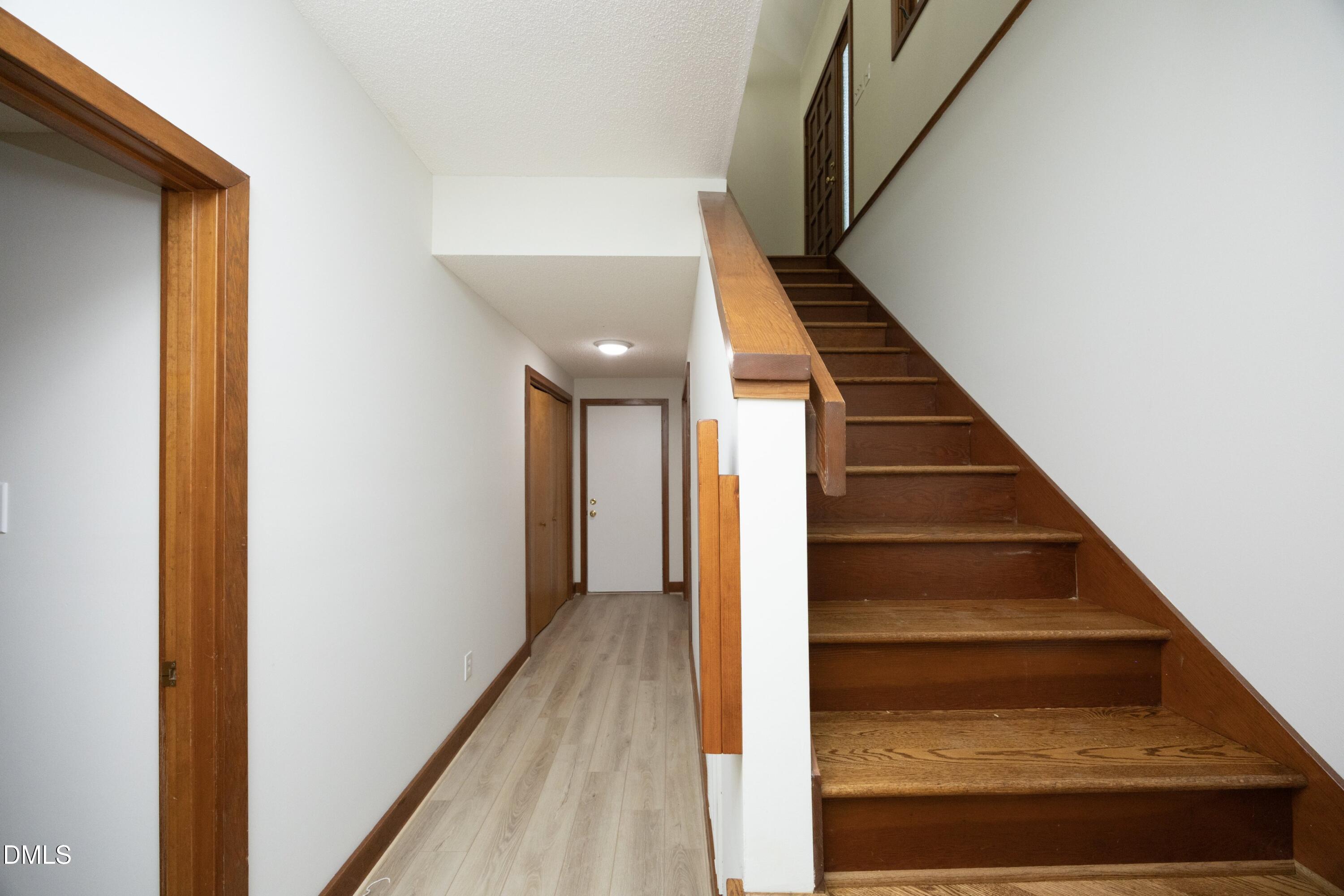 5321 Taproot Lane Durham, NC 27705 - Photo 20 of 27 a view of staircase with wooden floor and white walls