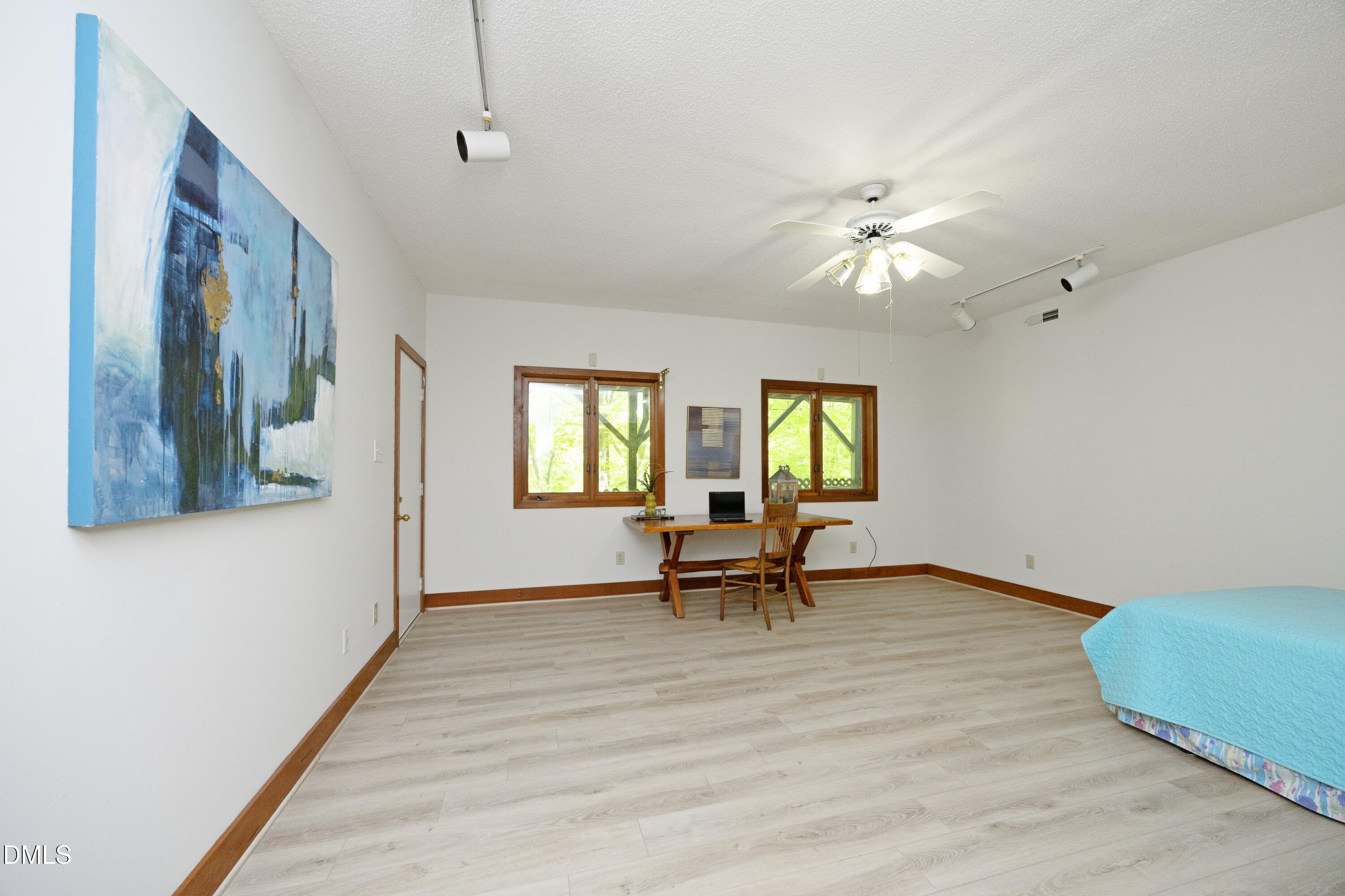 5321 Taproot Lane Durham, NC 27705 - Photo 21 of 27 a view of an empty room with a window and wooden floor
