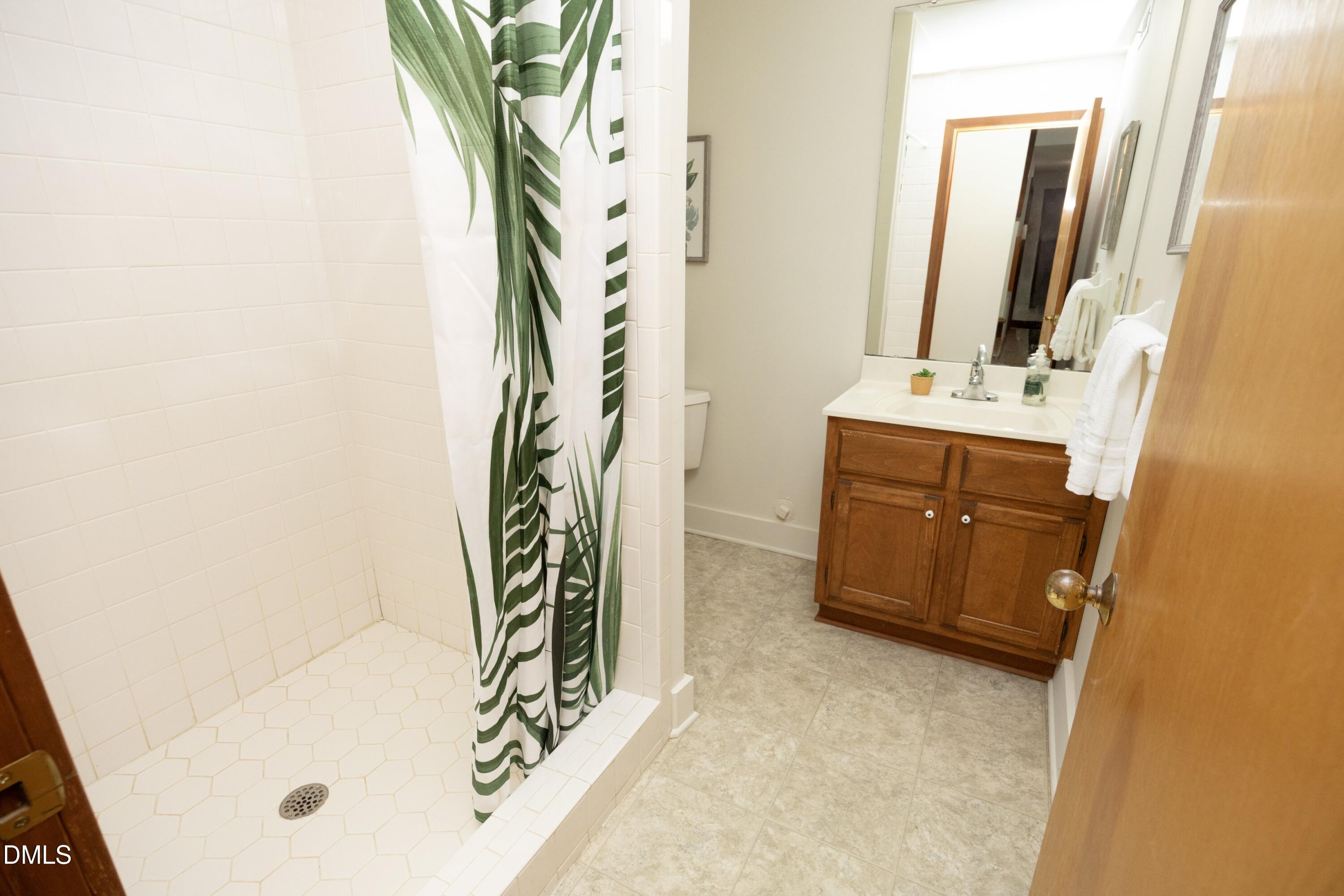 5321 Taproot Lane Durham, NC 27705 - Photo 23 of 27 a bathroom with a tub sink and mirror