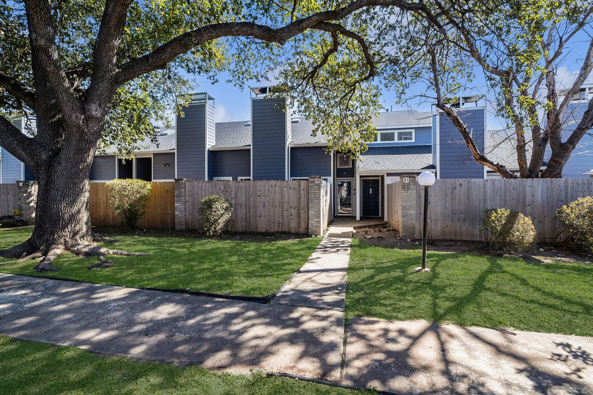 1010 West Rundberg Lane, Unit 30 Austin, TX 78758 - Photo 28 of 30 a view of a house with a yard