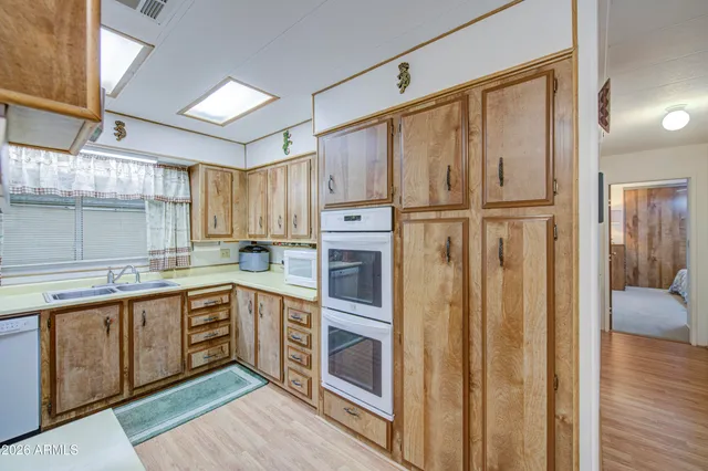 a kitchen with stainless steel appliances a refrigerator and wooden cabinets