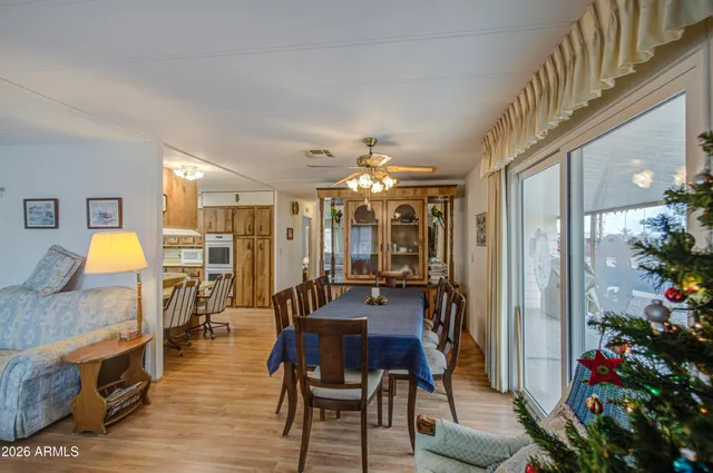 a view of a dining room with furniture and a chandelier