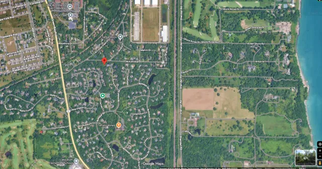 an aerial view of a house with a yard and greenery